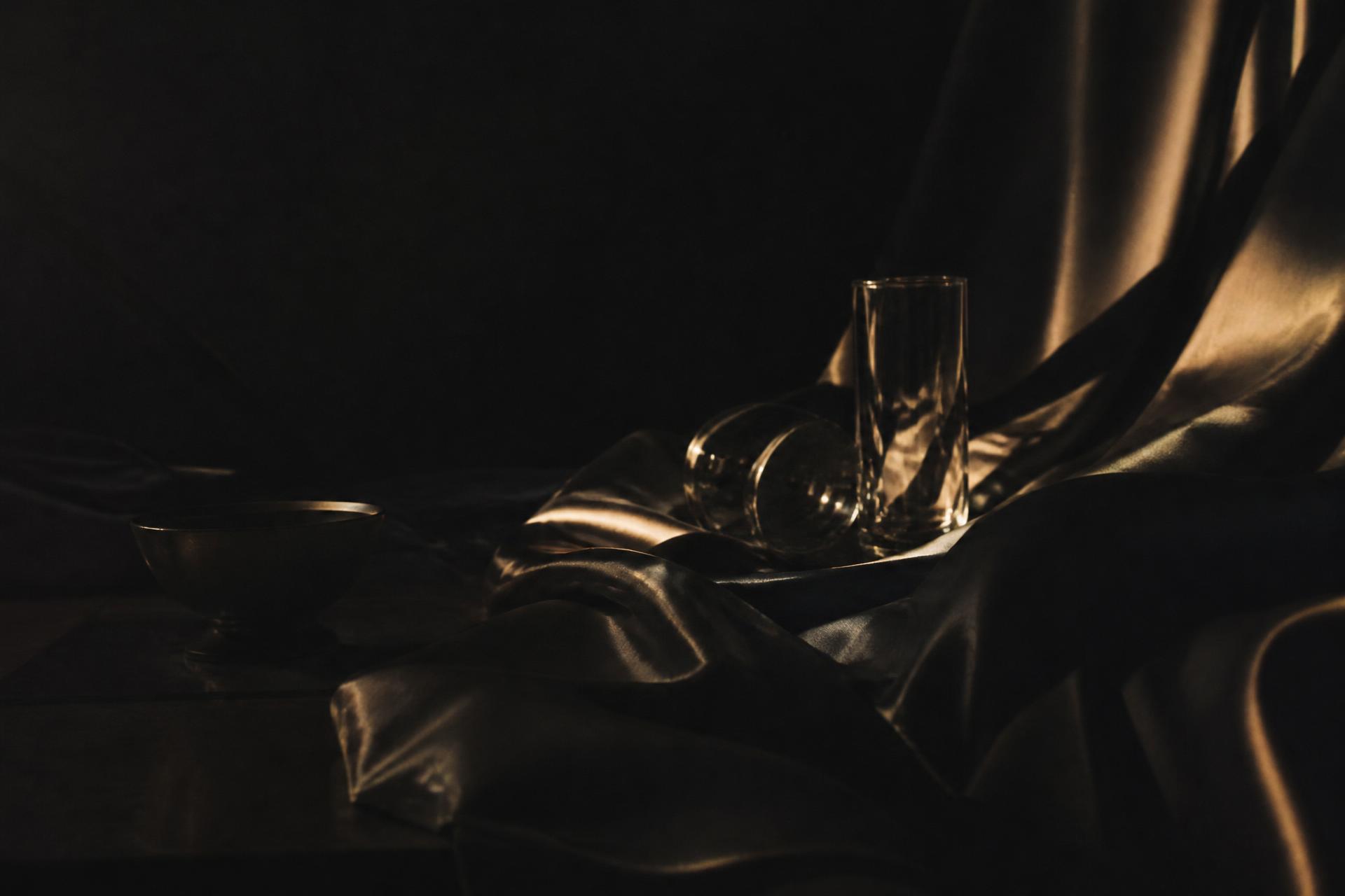 Cinematic champagne light across dark silk — SMK SocialXperience creative direction